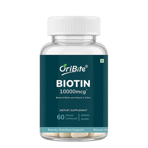 A clear plastic bottle of OriBite Biotin 10000mcg dietary supplement with a white cap and a dark teal label, containing 60 vegan capsules.