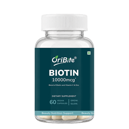 A clear plastic bottle of OriBite Biotin 10000mcg dietary supplement with a white cap and a dark teal label, containing 60 vegan capsules.