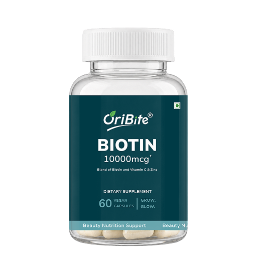 A clear plastic bottle of OriBite Biotin 10000mcg dietary supplement with a white cap and a dark teal label, containing 60 vegan capsules.