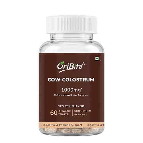 A clear plastic bottle of OriBite Cow Colostrum 1000mg dietary supplement with a white ribbed cap and a brown label, containing 60 chewable tablets visible at the bottom, on a white background.