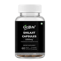 A bottle of OriBite Shilajit Capsules 1000mg dietary supplement, featuring a black label and white cap, containing dark brown resin pieces visible at the bottom.